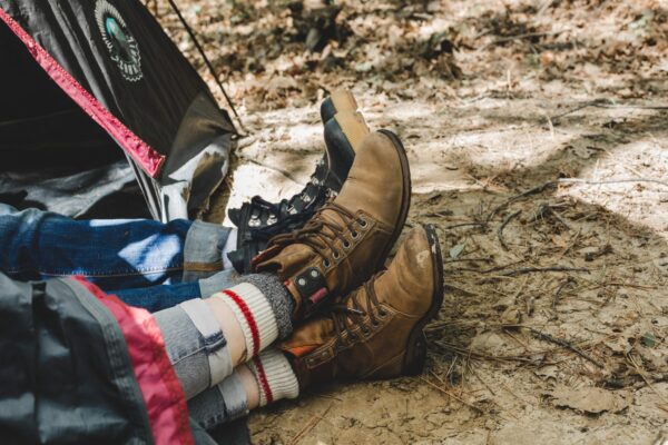 Couple wearing boots relaxing on a camping trip