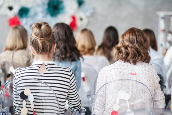 women sitting in a conference