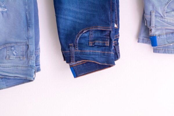 photo of three pairs of jeans in different wash